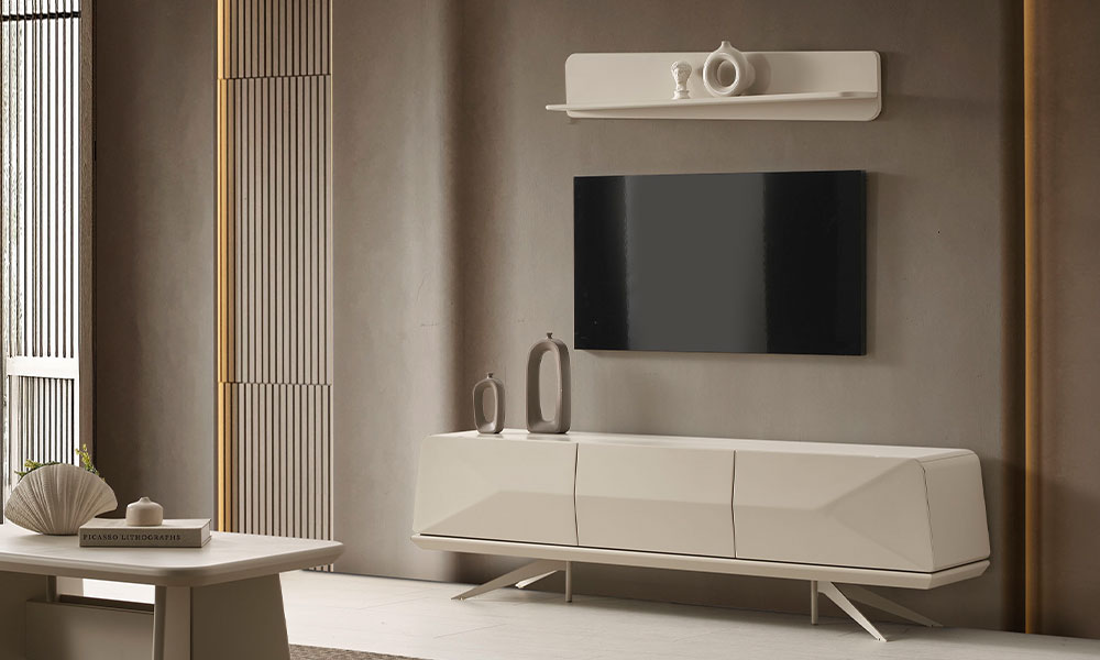 Vakko Modern TV Ünitesi'nin bej renkte, geometrik kesimli üç kapaklı alt sehpa modülü ve metal ayak detayları, sade duvarda.