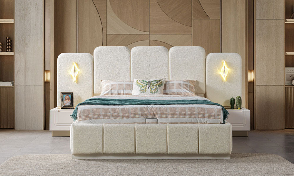 İklim Modern bazalı karyolanın önden görünümü; yüksek kanallı kumaş başlığı, entegre LED aplik aydınlatmaları ve komodinleri.