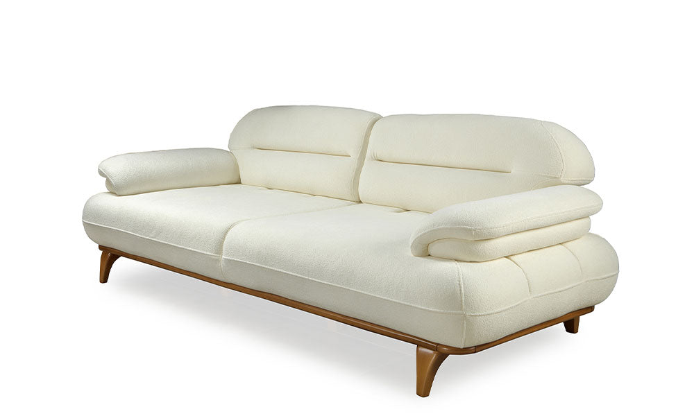 Lotus Modern üçlü koltuğun krem rengi coco kumaş kaplı, ahşap ayaklı yandan görünümü.
